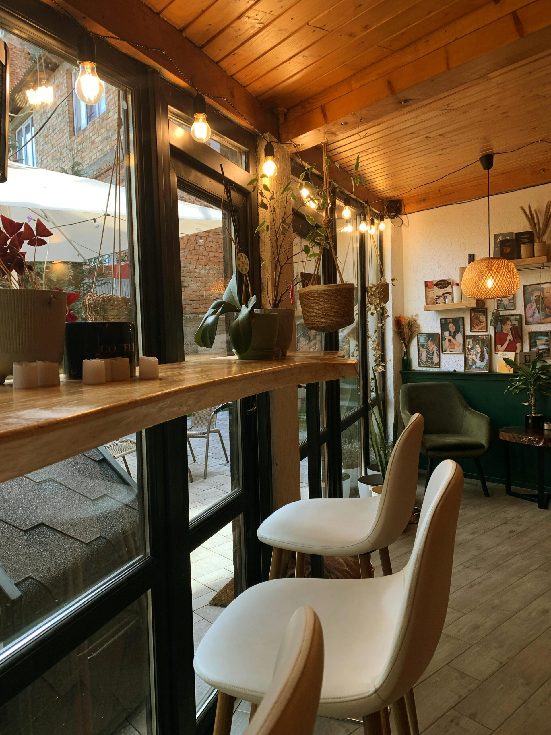 Elegant cafe space featuring stylish decor, plants, and warm lighting.